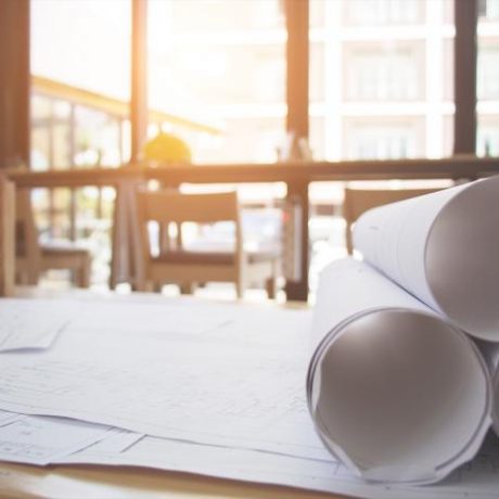 Architectural blueprints and construction plans on a table